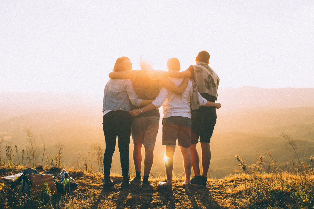 Group of Friends Hugging in Sunset